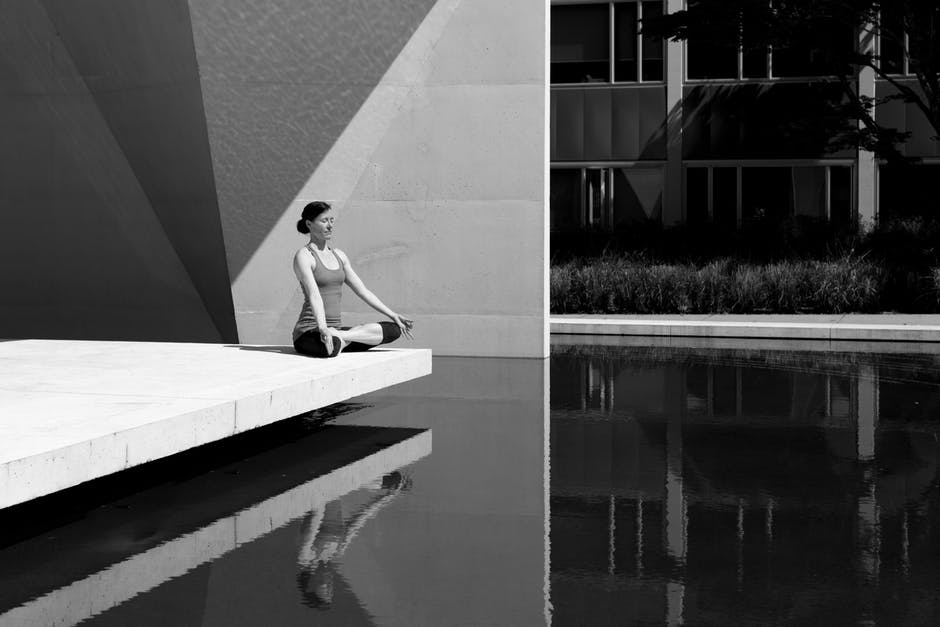 lady doing yoga at a reflection pond